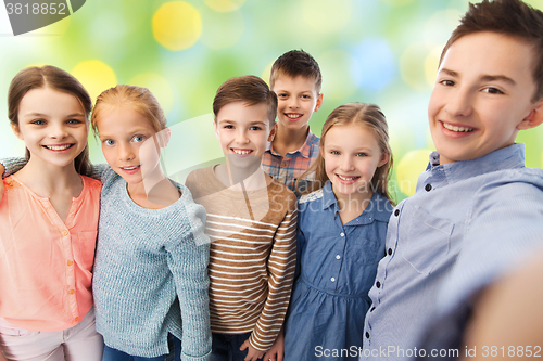 Image of happy children talking selfie