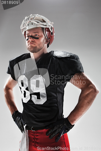 Image of American football player posing with ball on white background