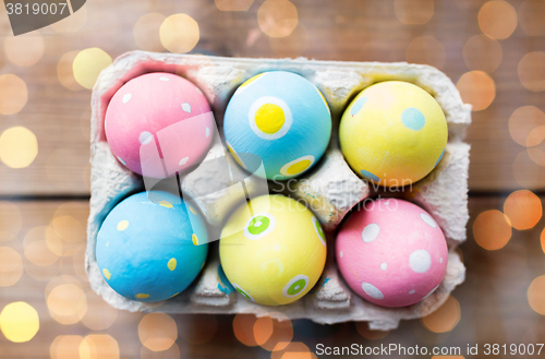 Image of close up of colored easter eggs in egg box