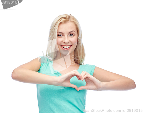 Image of happy woman or teen girl showing heart shape sigh