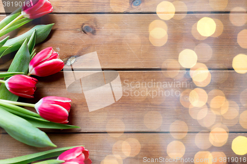 Image of close up of tulip flowers on wooden table