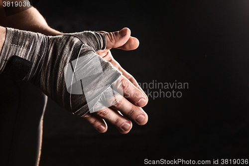 Image of Close-up hand of muscular man with bandage