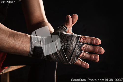 Image of Close-up hand of muscular man with bandage