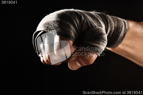 Image of Close-up hand of muscular man with bandage