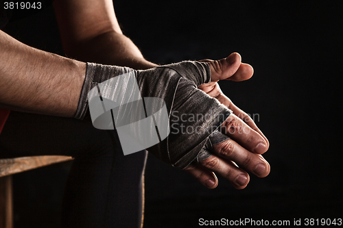 Image of Close-up hand of muscular man with bandage