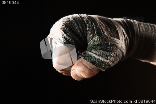 Image of Close-up hand of muscular man with bandage