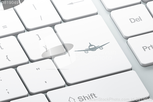 Image of Tourism concept: Aircraft on computer keyboard background