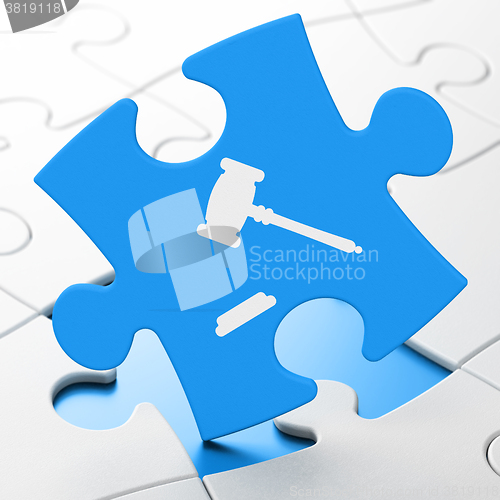 Image of Law concept: Gavel on puzzle background