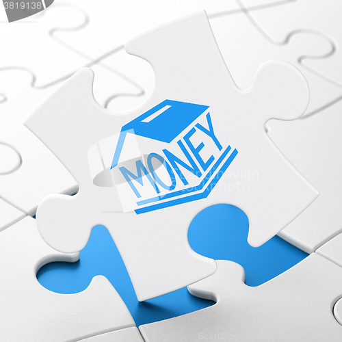 Image of Currency concept: Money Box on puzzle background