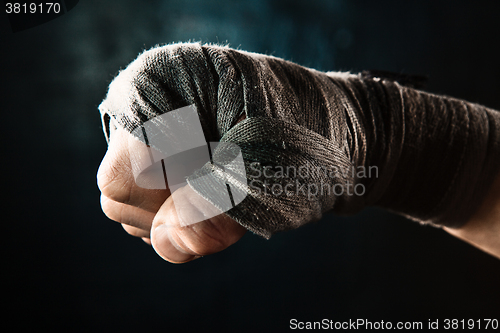 Image of Close-up hand of muscular man with bandage