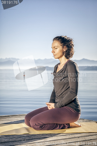 Image of yoga woman sitting lake