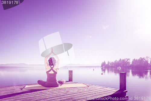 Image of yoga woman sitting lake