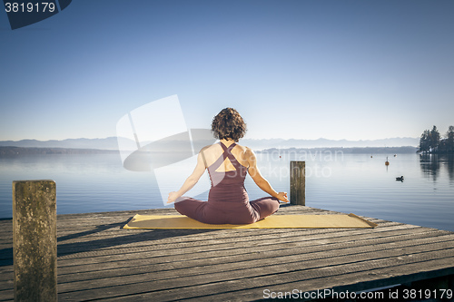 Image of yoga woman sitting lake
