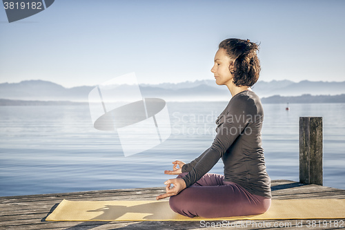 Image of yoga woman sitting lake