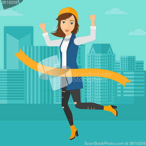 Image of Business woman crossing finish line.