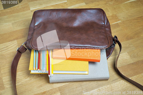 Image of books and pencils in the leather backpack