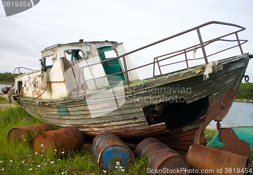 Image of Old whaleboat stranded on shore 