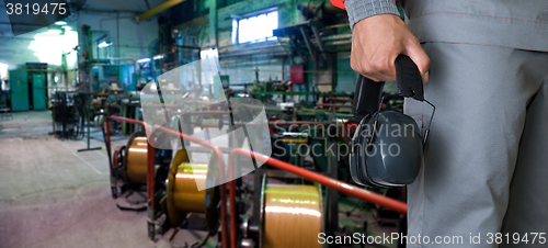 Image of Worker with protective headphone