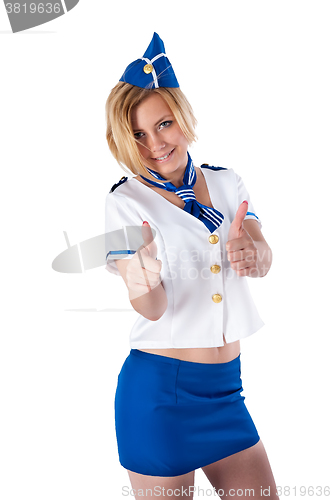 Image of Young beautiful air hostess shows thumbs up