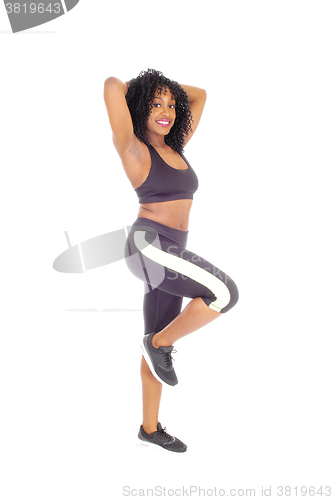 Image of African American woman standing in exercise outfit.