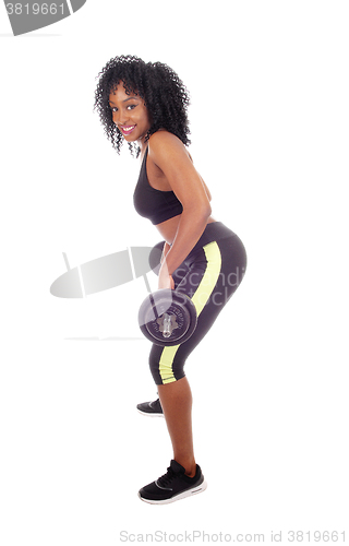 Image of African American woman lifting weight .