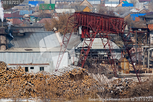 Image of pile of wood logs on plywood combine. Tyumen