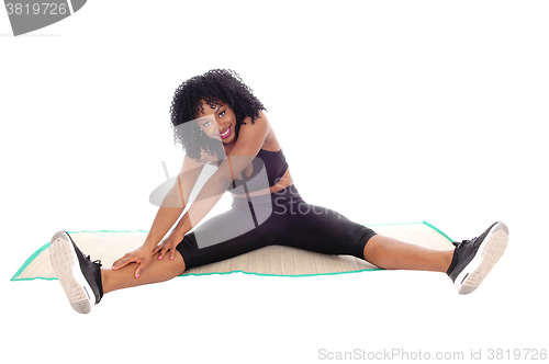 Image of African American woman stretching.