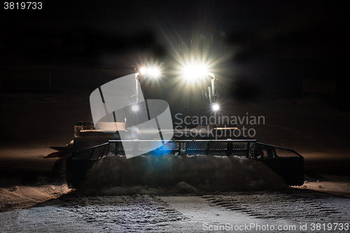 Image of Snowcat preparing a slope at night 