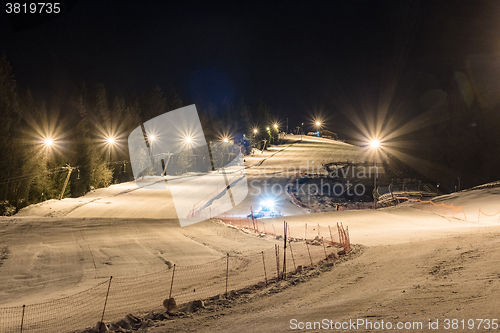 Image of Snowcat preparing a slope at night 