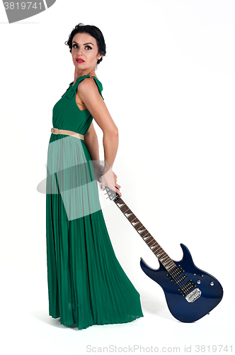 Image of Pretty woman in long dress with guitar