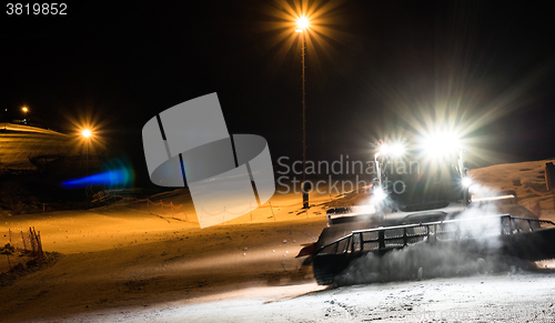 Image of Snowcat preparing a slope at night 