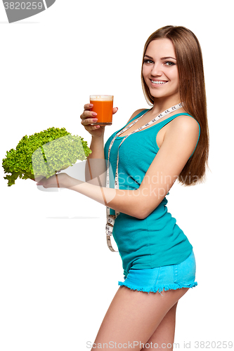 Image of Happy teen girl holding a glass of carrot juice