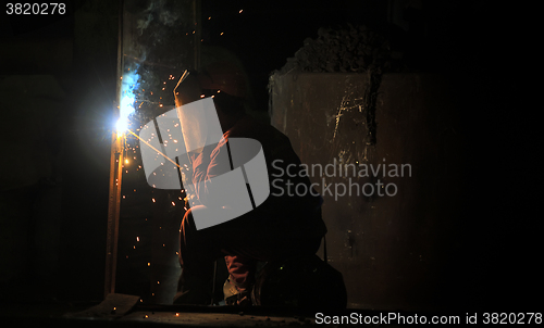 Image of worker welding steel 