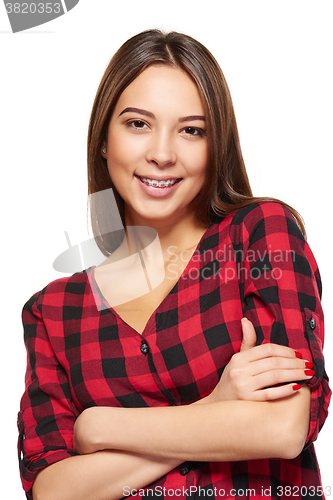 Image of Teen female smiling with braces on her teeth