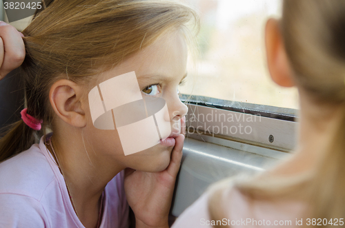 Image of The girl glared at the other girl in electric windows