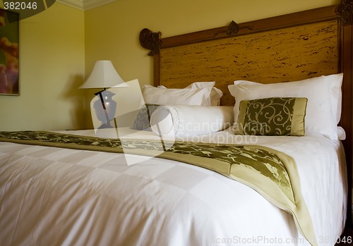 Image of King sized bed in a hotel suite room

