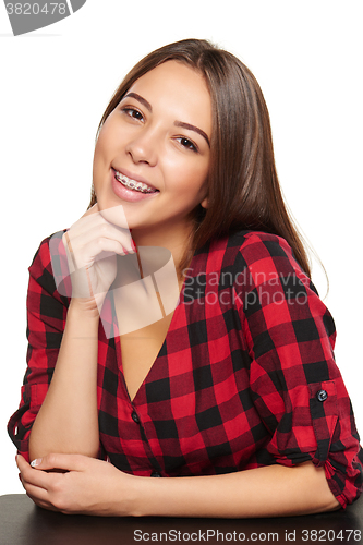 Image of Teen female smiling with braces on her teeth