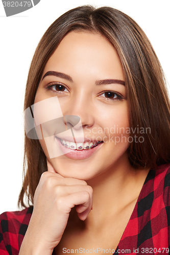 Image of Teen female smiling with braces on her teeth