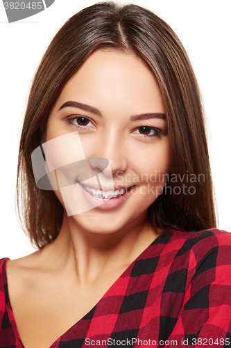 Image of Teen female smiling with braces on her teeth
