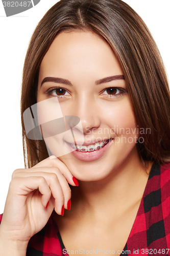 Image of Teen female smiling with braces on her teeth
