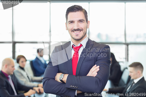 Image of Team leader with coworkers working in office.