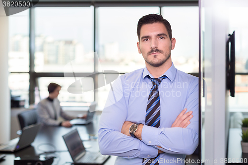 Image of Team leader with coworkers working in office.