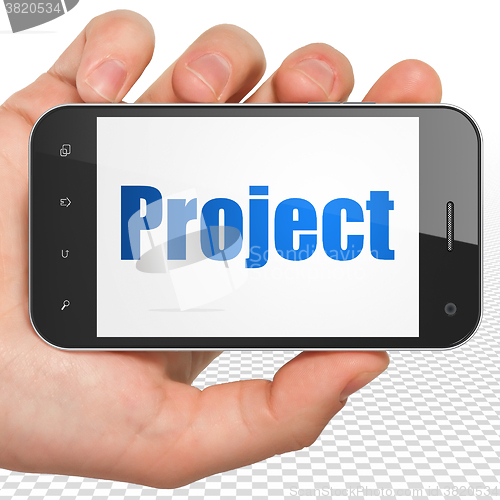 Image of Finance concept: Hand Holding Smartphone with Project on display