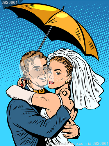 Image of Couple in love bride and groom under an umbrella