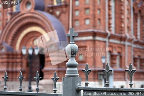 Image of metallic fence decoration with cross 