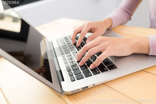 Image of Woman typing on laptop computer