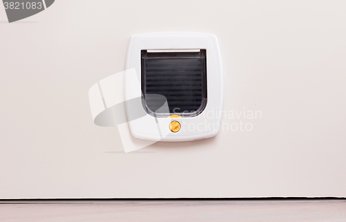 Image of Inside view of a regular white cat flap, flap closed