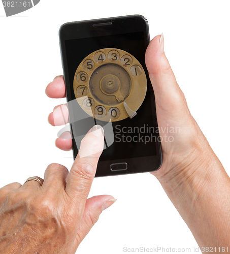 Image of Senior woman hand with smart phone isolated, old fashion dial