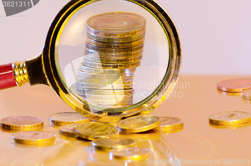 Image of A stack of coins under a magnifying glass