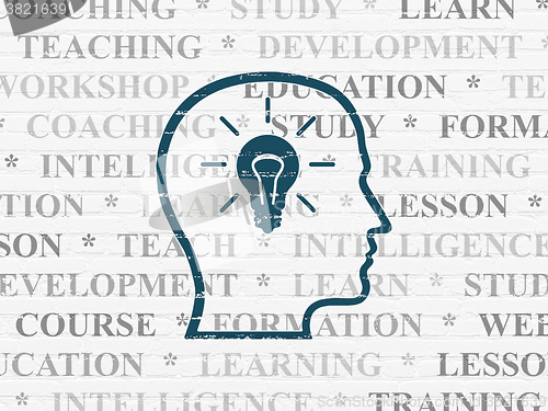 Image of Education concept: Head With Lightbulb on wall background